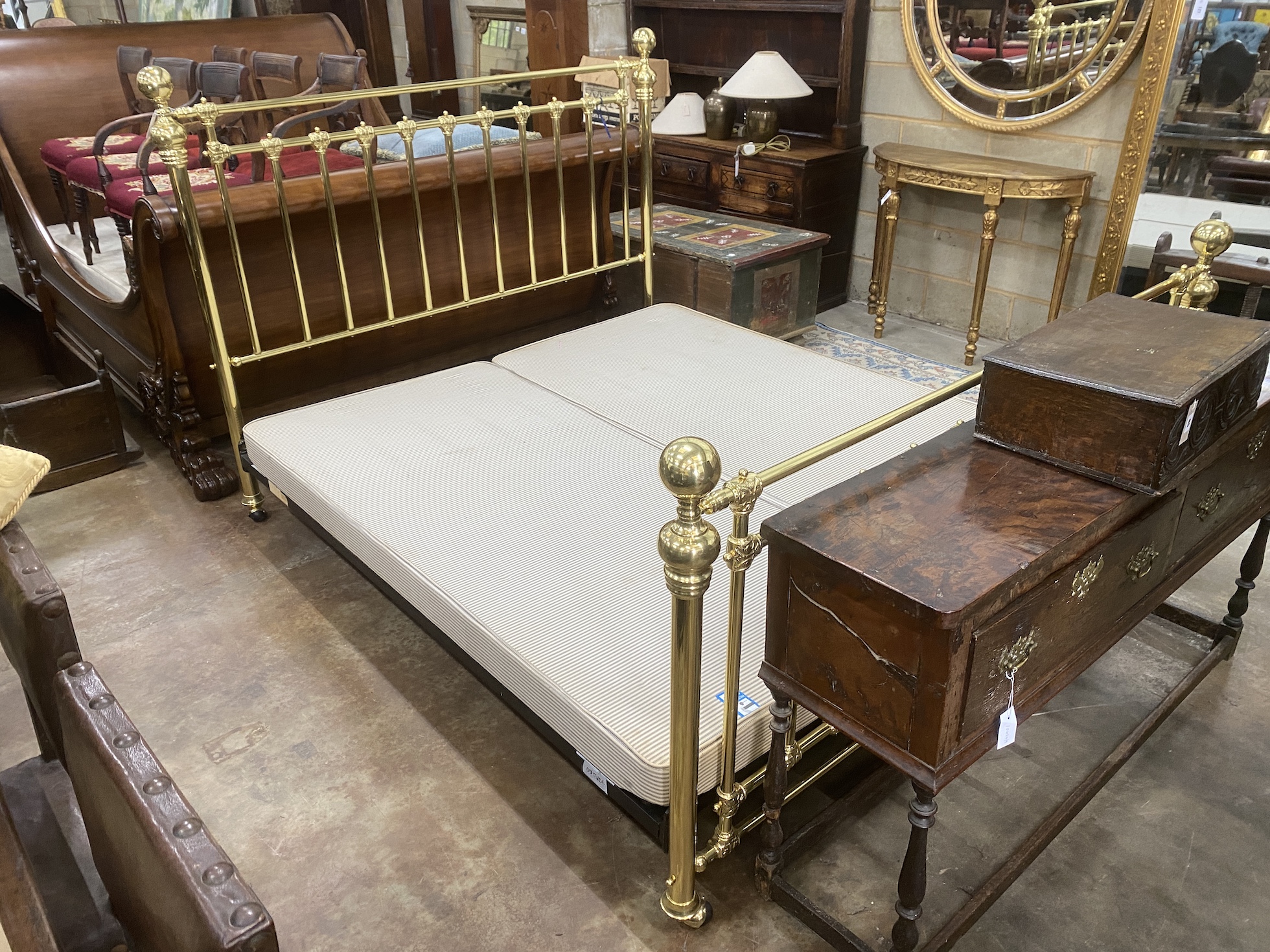 A Victorian style super kingsize tubular brass bedstead, with box base, length approx. 220cm, width 188cm, height 141cm